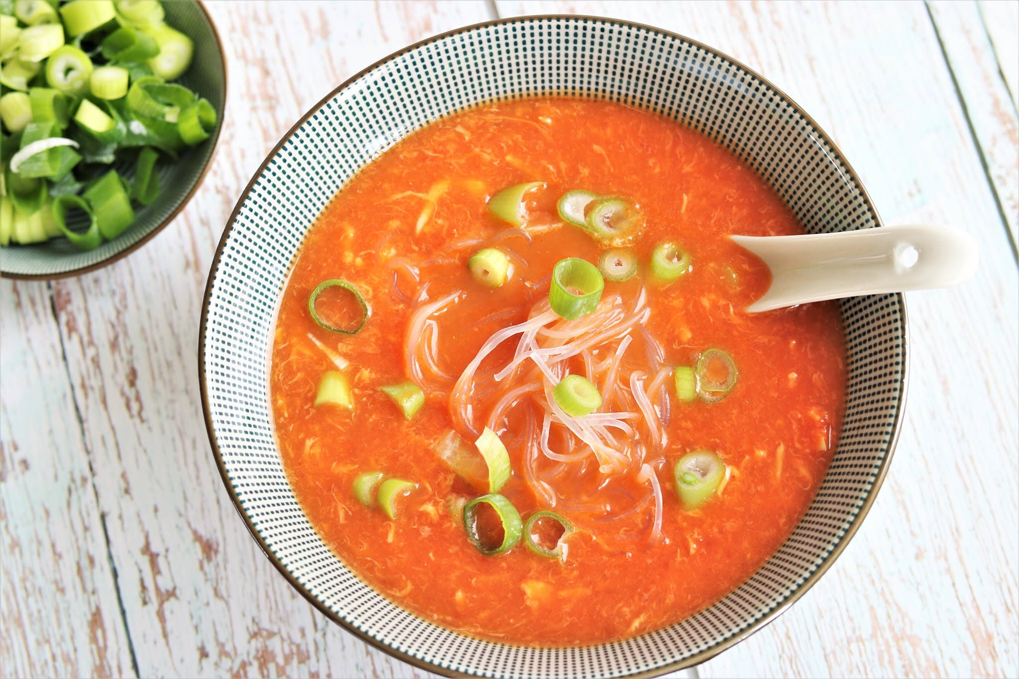 Orange soup garnished with spring onion